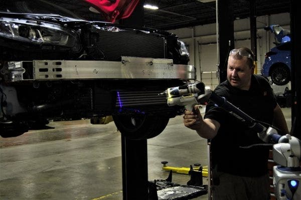 Lead engineer working on scanning the front of the car into a computer file